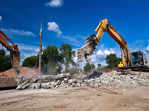 Demolition-site-with-heavy-equipment-breaking-down-concrete.jpg