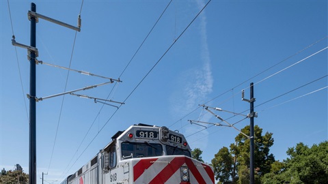 Caltrain-diesel-engine-amidst-electrification-project-poles-and-wires.jpg