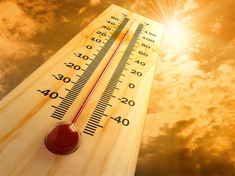 Wooden-thermometer-showing-high-heat-in-front-of-orange-sun.jpg