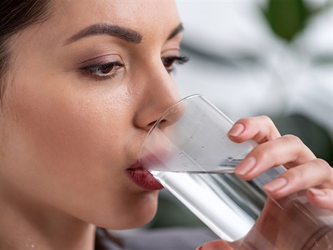 Close-up-of-woman-drinking-water-from-a-glass.jpg