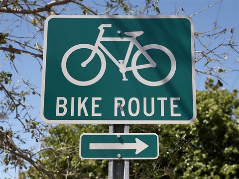 Green-bike-route-traffic-sign-with-bicycle-symbol-and-arrow.jpg