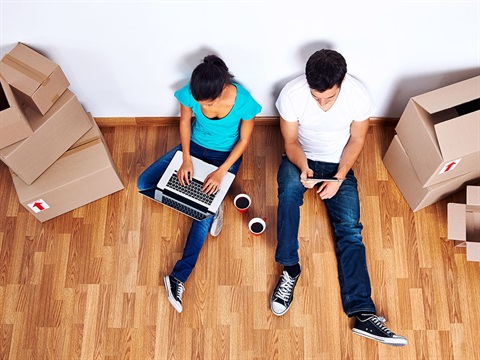 Couple-takes-a-break-on-the-floor-between-moving-boxes.jpg