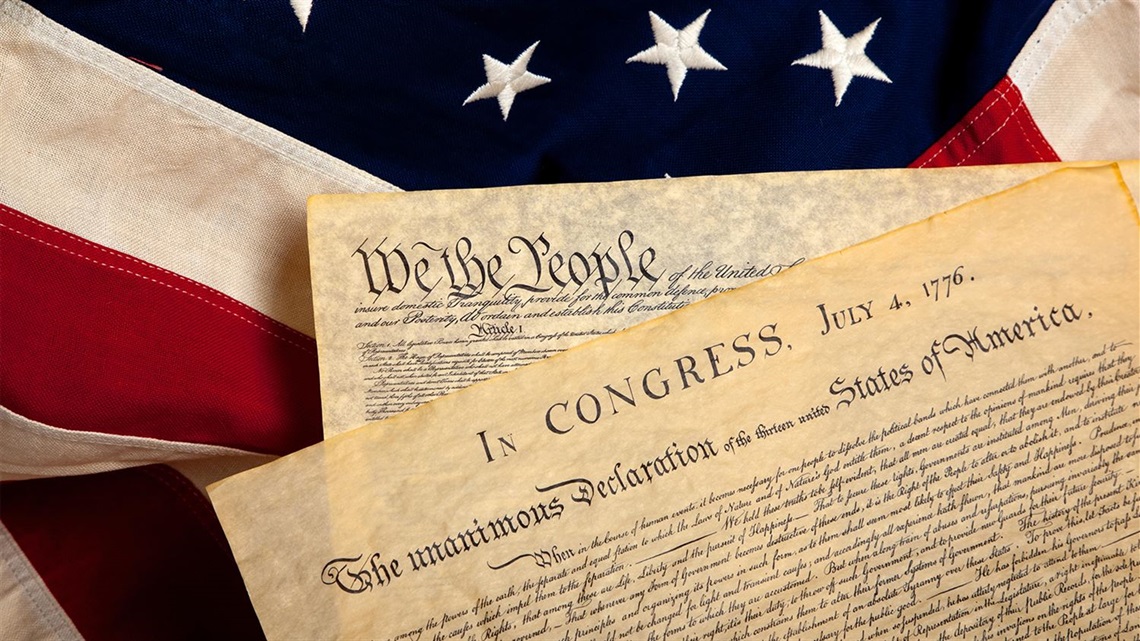 Parchment-paper-copy-of-the-Declaration-of-Independence-on-top-of-American-Flag.jpg