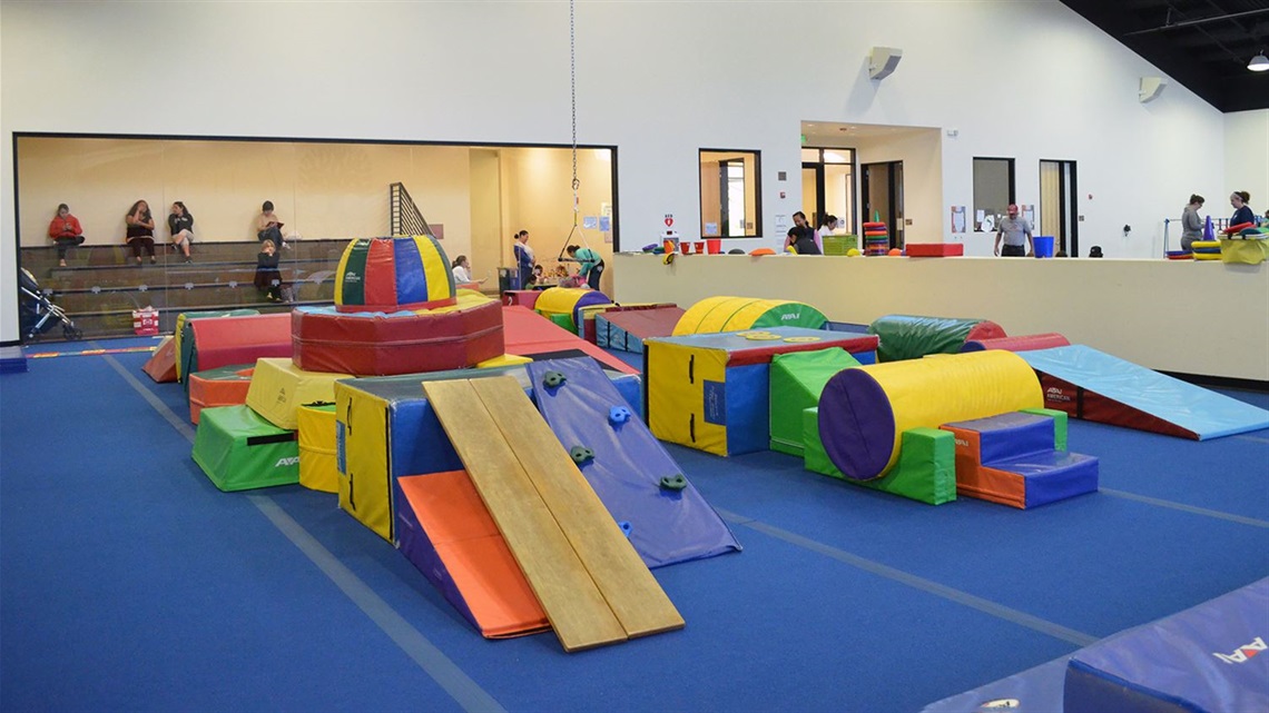 Arrillaga-Family-Gymnastics-Center-interior-with-participant-families-watching-from-waiting-room.jpg