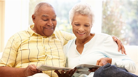 Two seniors reading together on couch.jpg