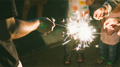 hands holding sparklers