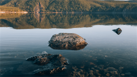 Mountains in background with lake and rocks