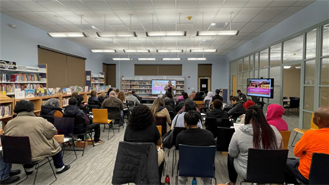 Person giving presentation to seated audience