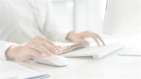 Hands typing at computer