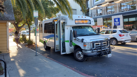 A Caltrain shuttle bus on a street