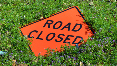 Road closed sign in grass