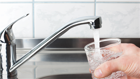 Filling glass with water from faucet
