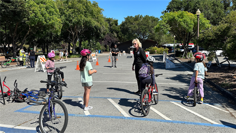 Young bicyclists and an adult volunteer