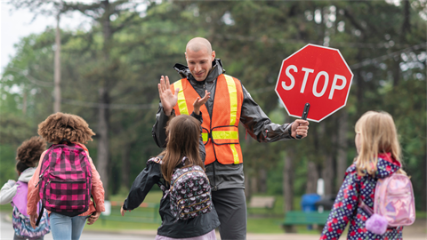 Crossing guard with school children