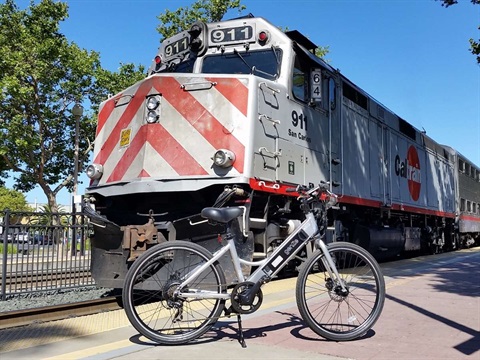 Caltrain at station with E-Bike.jpg