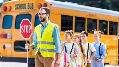 Crossing guard leading students.jpg