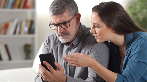 Father and daughter looking at phone.jpg