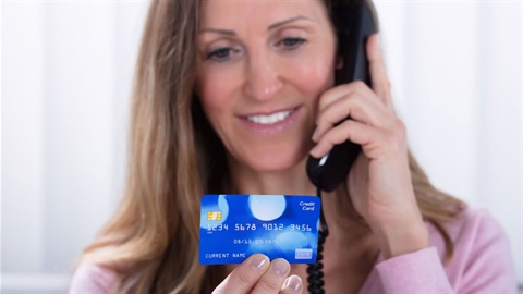 Female on phone holding credit card.jpg