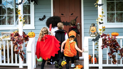 Four children in costumes trick-or-treating.jpg