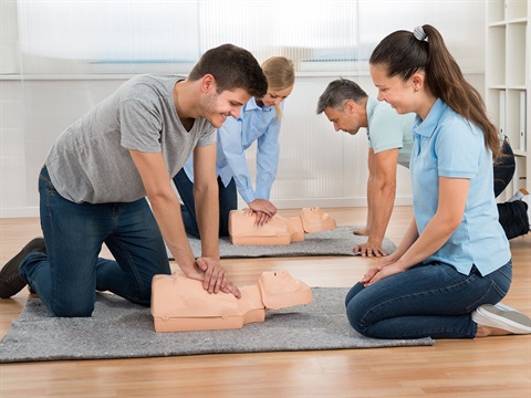 Four-people-practice-CPR-on-a-training-dummy-during-an-emergency-preparedness-class.jpg