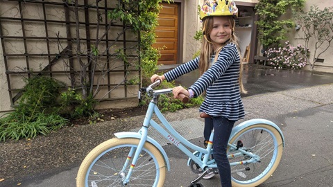 Girl biking on Ruby Bridges walk to School day.jpg