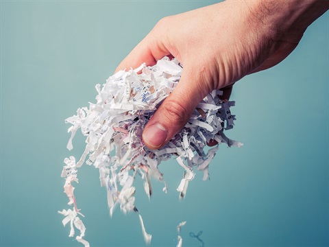 hand-drops-shredded-paper.jpg