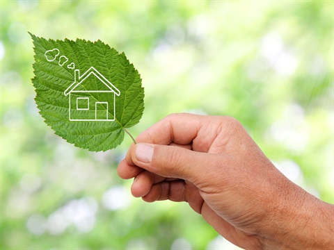 Home-icon-on-green-leaf-held-by-man.jpg