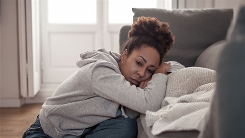 Mental health - woman sad resting head on couch.jpg