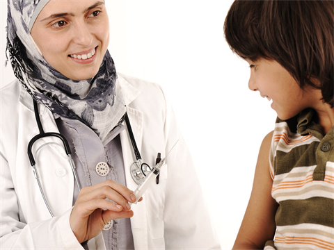 OpenCities--Muslim-female-doctor-readies-vaccine-syringe-for-young-boy.png