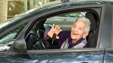 senior-woman-holds-car-keys-out-car-window.jpg