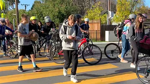 Students walking and biking through crosswalk on the way from school.jpg