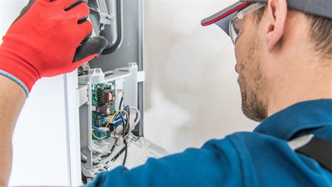 Technician checking gas furnace.jpg