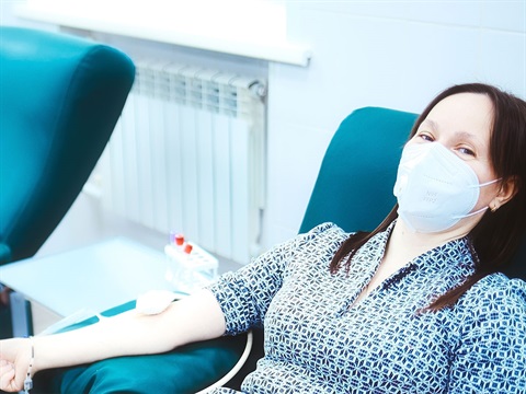 Woman-donates-blood-while-wearing-a-mask.jpg