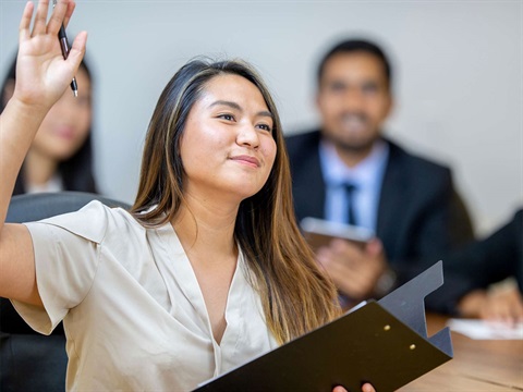 Woman-raising-her-hand-at-meeting.jpg