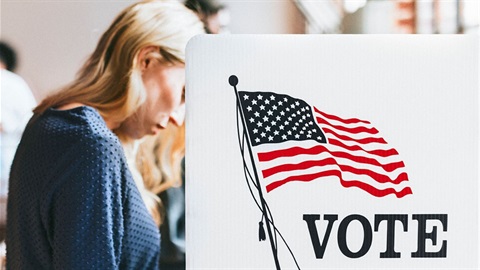 Woman stands and votes.jpg