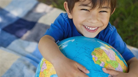 young boy holds globe.jpg