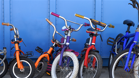 Childrens bikes in front of blue background