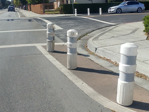 Temporary bulb out with bollards from Belle Have traffic calming plan pilot