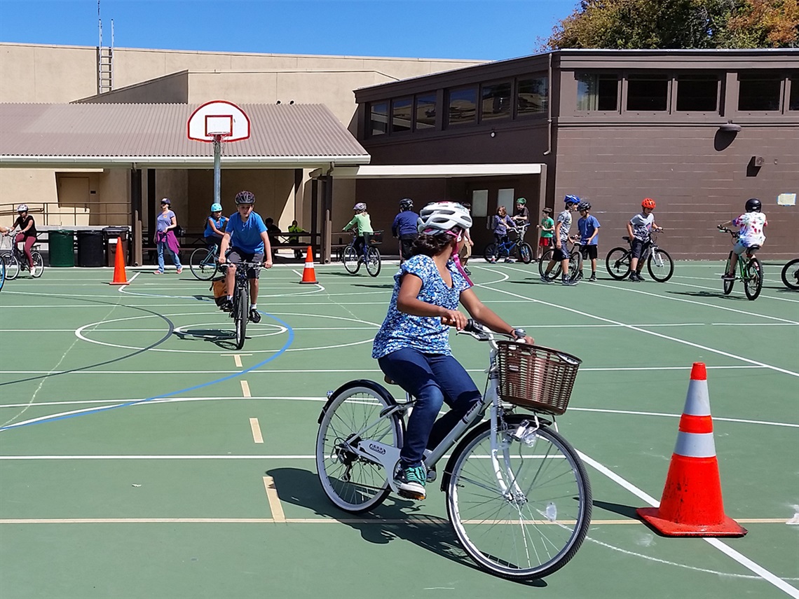 Bike-riders-navigate-an-obstacle-course-with-orange-cones